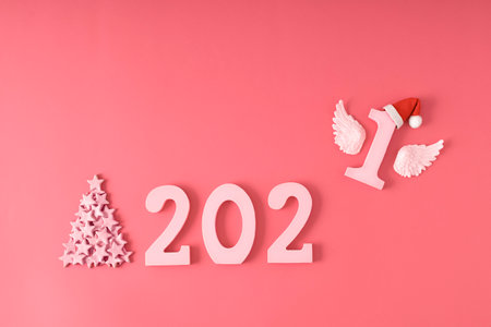 2021 New Year card made with pink numbers and stars. Flying number one. Holiday minimal flat lay...