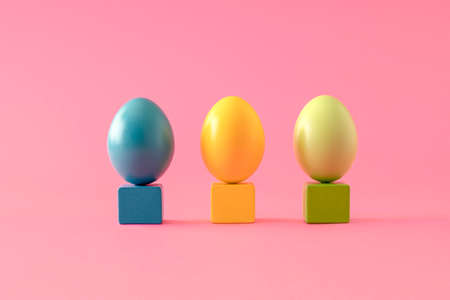 Trendy layout made of colorful Easter eggs on a small cube. Minimal holiday exhibition conceptの写真素材