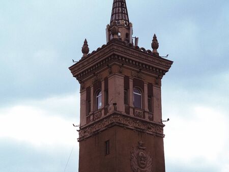 old beautyfull tower in the city center with a spireの写真素材