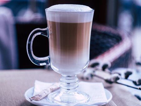glass with delicious latte in a cozy coffee shopの写真素材