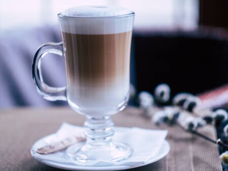 glass with delicious latte in a cozy coffee shopの写真素材