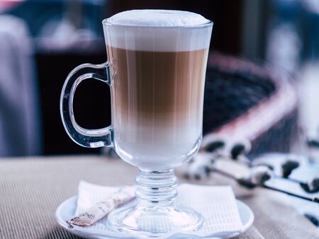 glass with delicious latte in a cozy coffee shopの写真素材