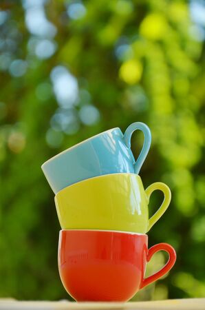 Stack of colorful mugs, colorful kitchenwareの写真素材