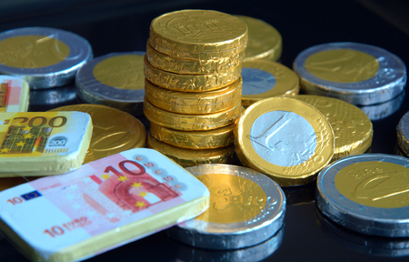 chocolate coins with black background for good luck, rich and wealthyの写真素材