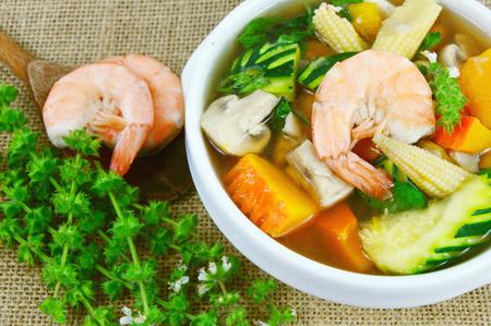 mixed vegetable soup Thai menu on sackcloth. Thai Spicy Mixed Vegetable Soup with Prawns (Thai name is Kang Liang Goong Sod).の写真素材