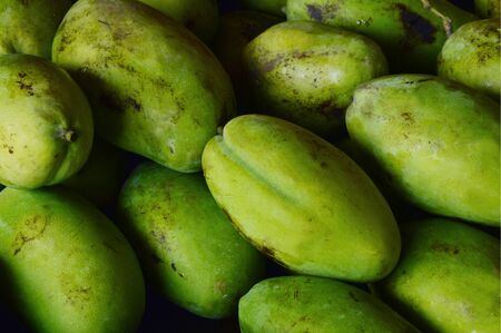 A lot of green mango with shadow.