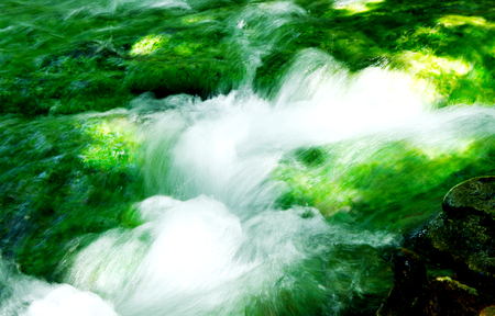 Water flowing into the Emerald Pool or Thai name is Sra Morakot Krabi Thailand.の写真素材