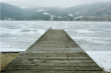 Wooden bridge on the frozen lake.の写真素材