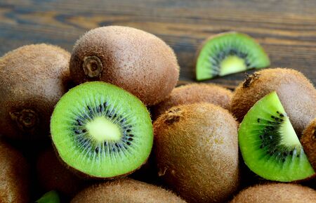 A lot of fresh kiwi fruit on wooden floorの写真素材