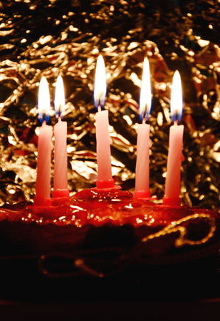 Birthday cake with candles and bohke in the dark roomの写真素材