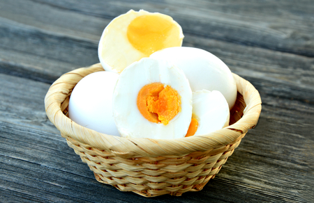 Salted duck egg in basket on wooden backgroundの写真素材