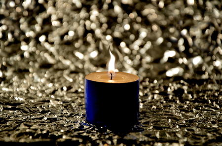Light candles in the dark with boho background and space for textの写真素材