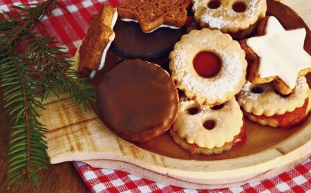 Mixed a lot of Christmas cookies on wooden dish.