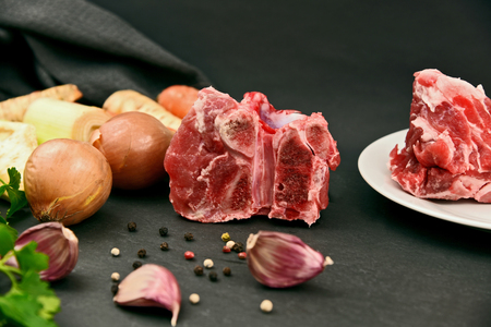 Ingredient for making Pork Stock.
Clear soup with pork bones full frame on black stone background.の写真素材