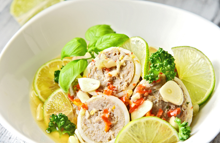 steamed filled squid in lime sauce (Thai name is Pla Muk Nung Manow).Squid and minced pork ...