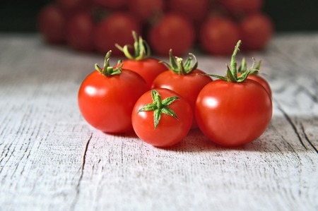 Healthy and benefits of cheery tomatoes.Fresh Cheery tomatoes on white woodenの写真素材