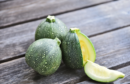 Round summer squash or Round zucchini  on wooden background.の写真素材