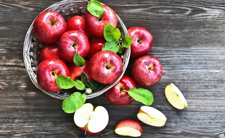 a lot of Red apples or Gala apples with fresh leaf  on wooden background.の写真素材