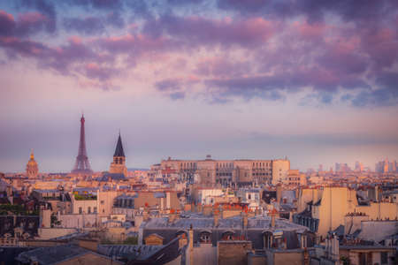 Eiffel tower and parisian roofs at golden sunrise Paris, Franceの写真素材