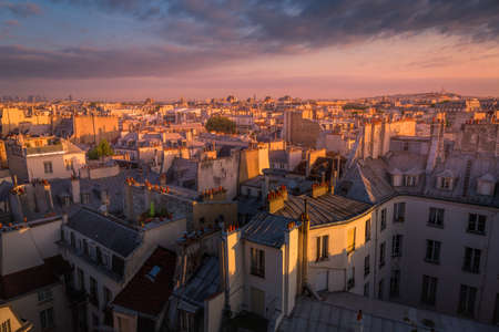 Parisian roofs of Montparnasse and Montmartre at dramatic sunset Paris, Franceの写真素材