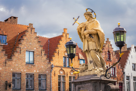 Statue of Saint Joannes Nepomucenus in Bruges and flemish architecture, Belgiumの写真素材