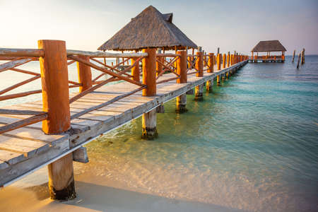Tropical paradise: Cancun idyllic caribbean beach with with rustic palapa pier, Riviera Maya, Mexicoの写真素材
