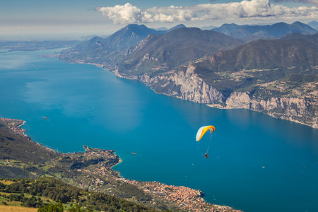Paragliding above idyllic Lake Garda from Monte Baldo, Malcesine, Italyの写真素材