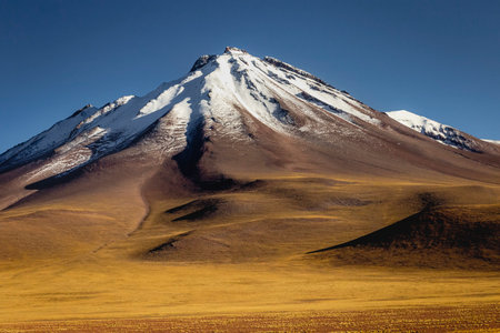 Atacama desert, snowcapped volcano and arid landscape in Northern Chileの写真素材