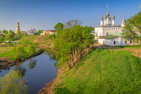 Orthodox church at golden sunrise with river, Suzdal, Russiaの写真素材