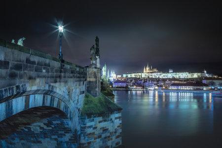 Charles bridge and Vltava river at night with blurred boat movement, Pragueの写真素材