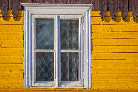 Yellow traditional ornate wooden farm house of eastern Europe, Lithuaniaの写真素材