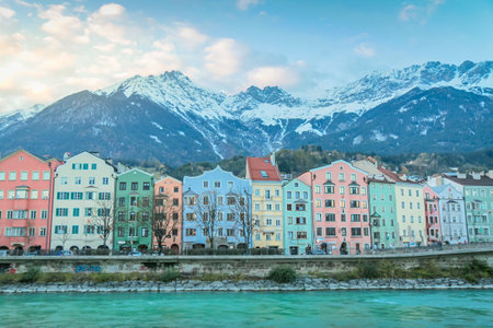 Innsbruck Old town and snowcapped karwendel mountain at sunset in Tyrol, Austriaの写真素材