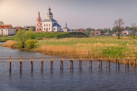 Orthodox church at golden sunrise with river, Suzdal, Russia