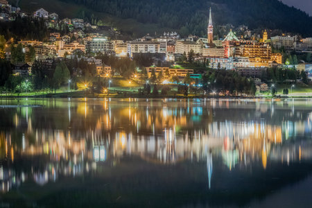 St Moritz illuminated cityscape and lake reflection at night, Engadine, Swiss alps, Switzerlandの写真素材