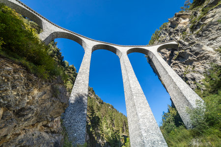 Swiss train over Landwasser Viaduct bridge in the alps, Graubunden, Switzerlandの写真素材