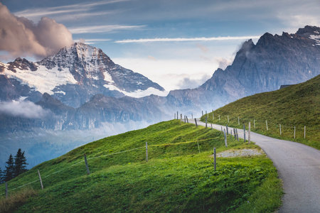 Snowcapped Bernese Swiss alps and mountain road in Murren, Switzerland