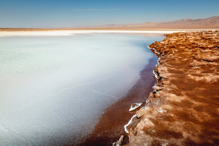 Salt lake reflection and idyllic volcanic landscape at sunrise, Atacama desert, Chile border with Boliviaの写真素材