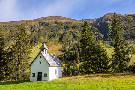 Idyllic landscape of church in Engadine valley at sunny springtime, Swiss Alps, Switzerlandの写真素材