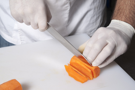 The cook cuts the carrotの写真素材