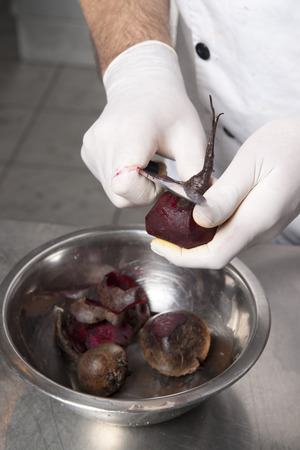 The cook cleans red beetsの写真素材