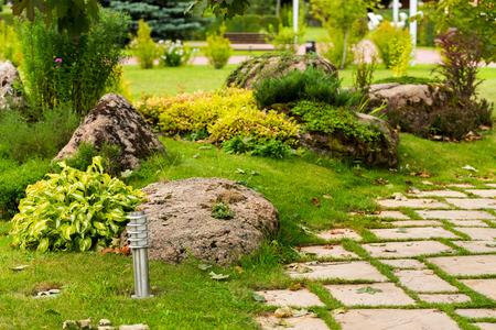ornamental bushes and stones in the landscape decoration of the flowerbedsの写真素材