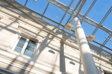 metal construction of a glass roof on a sunny day against the skyの写真素材