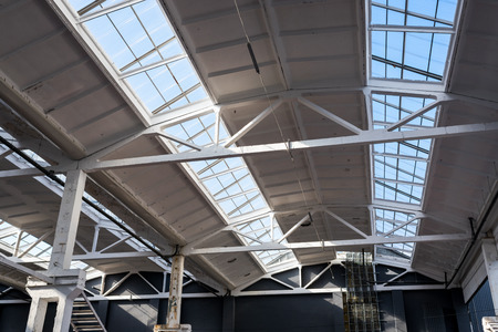 Industrial roof with glazing in the factory inside on a sunny day