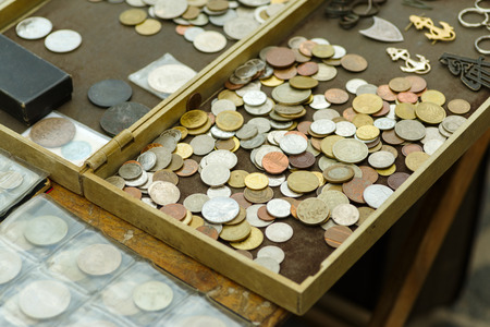 Old coins of different countries on the counter
