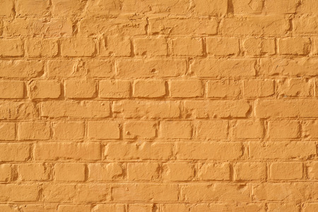 painted building brick wall in orange colorの写真素材