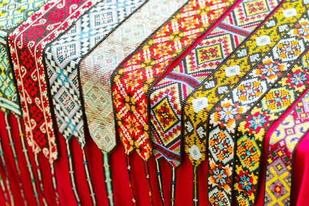 Different ethnic braided ornaments from beads around the neck for women with drawings, Ukrainian drawingsの写真素材
