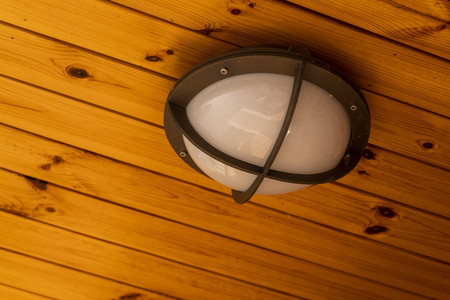 modern glass street lamp suspended to a wooden ceilingの写真素材