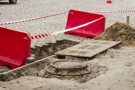 Road repair fenced with plastic traffic safety limitersの写真素材