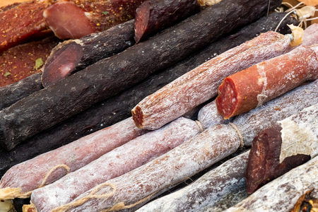 Many different smoked sausages in the store, close-upの写真素材