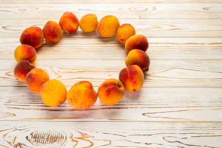 ripe peaches on a table lined in a circle